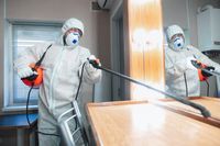 coronavirus-pandemic-disinfector-in-a-protective-suit-and-mask-sprays-disinfectants-in-the-house-or-office (4)